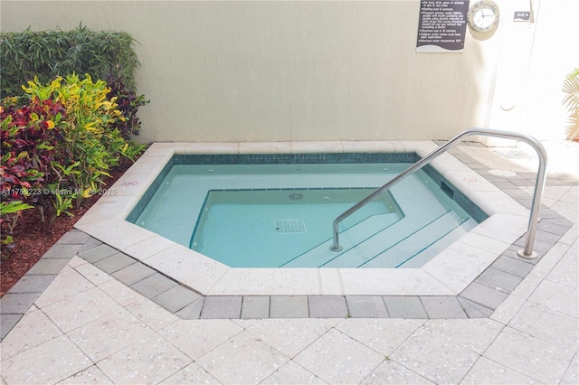 view of pool with a hot tub