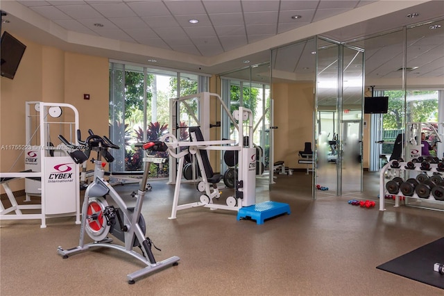 workout area with a paneled ceiling