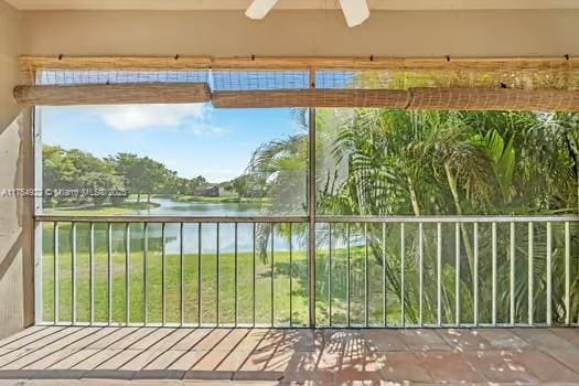 unfurnished sunroom featuring a water view