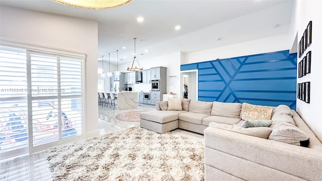 living room featuring recessed lighting and a notable chandelier