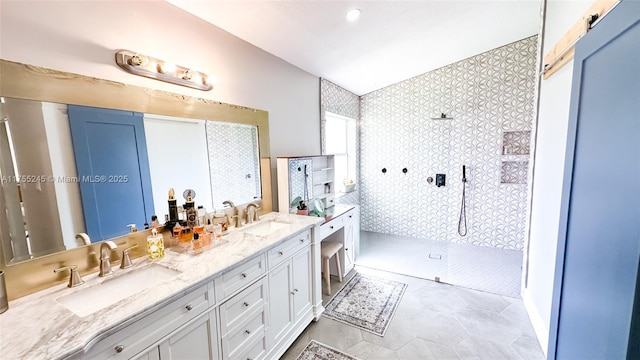 full bathroom featuring double vanity, a sink, and walk in shower