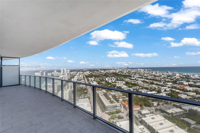 balcony with a water view and a city view