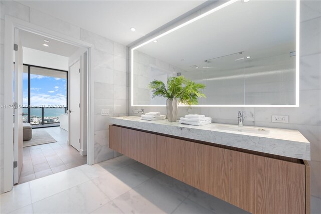 500 Alton Unit 3304, Miami Beach, FL 33139 - bathroom with tile walls, double vanity, a water view, and marble finish floors