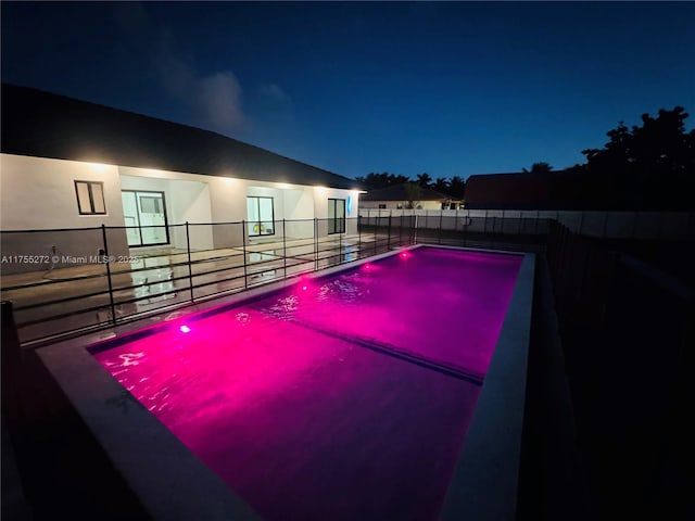 pool at night with fence