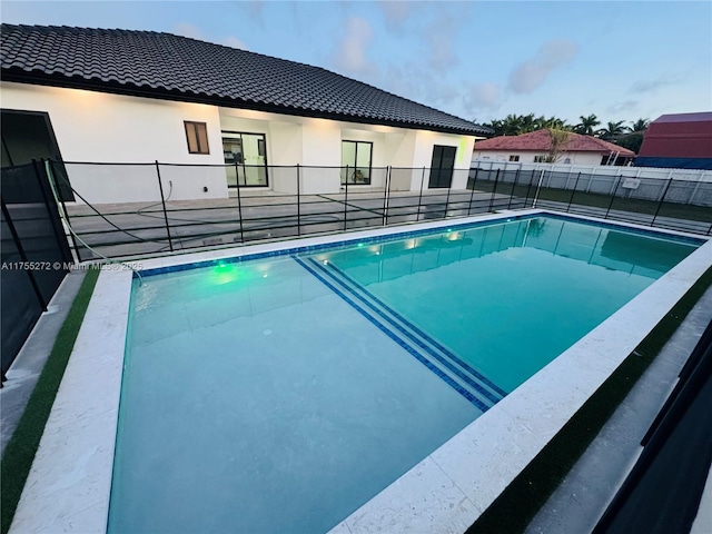 view of swimming pool featuring fence and a fenced in pool