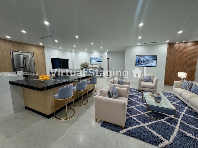 living room featuring recessed lighting, visible vents, and finished concrete floors