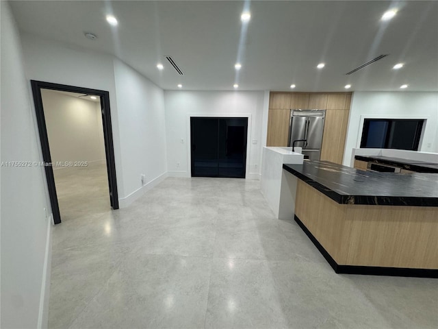 kitchen with visible vents, modern cabinets, dark countertops, recessed lighting, and high quality fridge