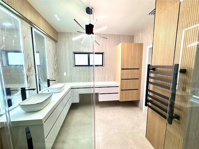 full bathroom with tile patterned flooring, double vanity, and a sink