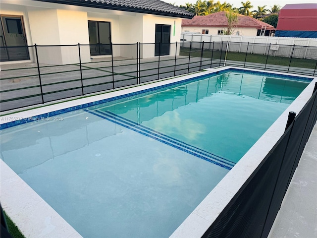 view of swimming pool with a fenced in pool and fence