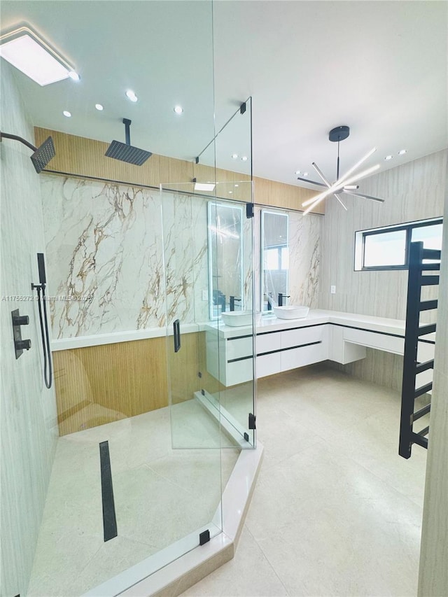 full bath featuring recessed lighting, a marble finish shower, and vanity