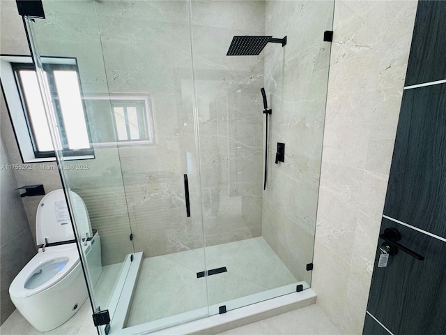 bathroom featuring a shower stall and toilet