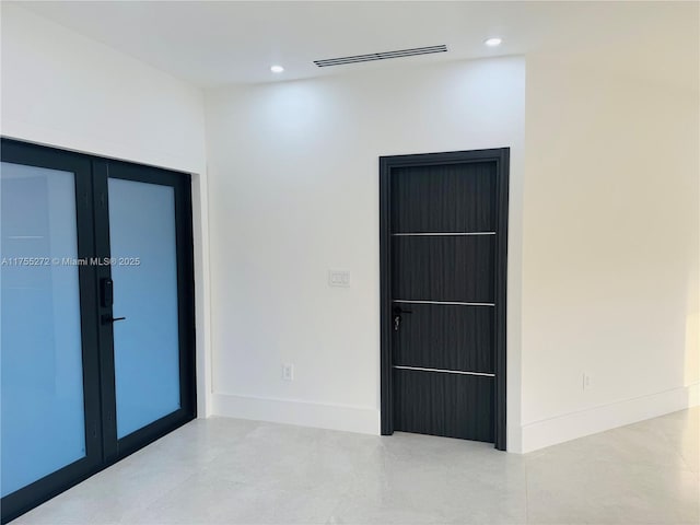 empty room featuring recessed lighting, french doors, baseboards, and visible vents