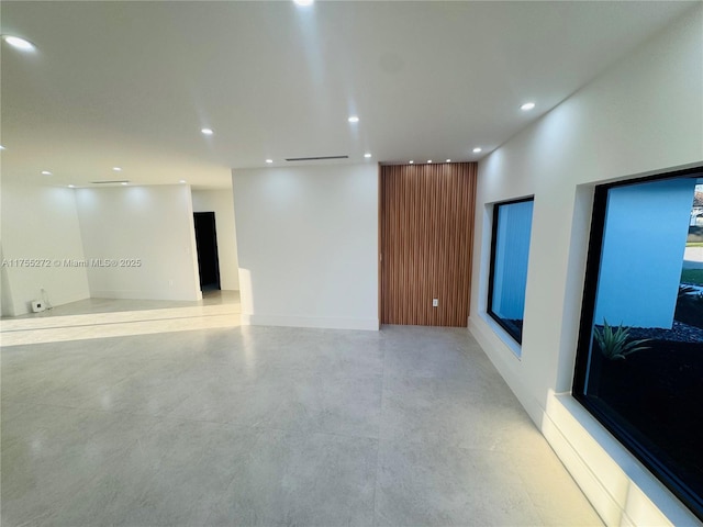 unfurnished room featuring finished concrete floors and recessed lighting