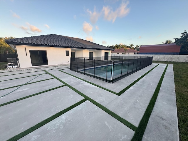 view of pool with a fenced in pool, a patio area, and fence