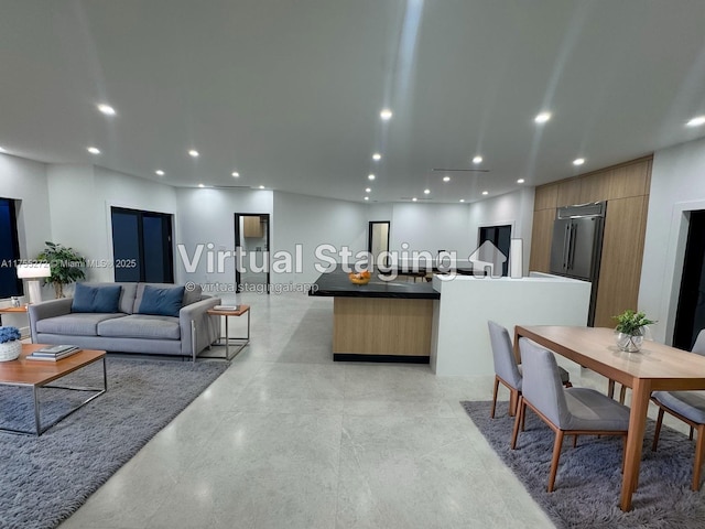 living area featuring recessed lighting and finished concrete floors