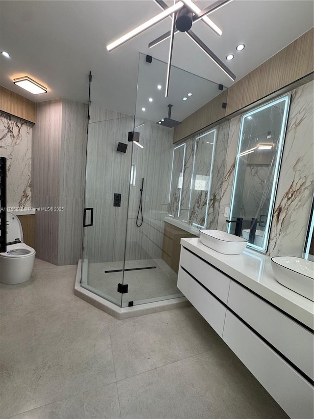 full bathroom with vanity, a shower stall, recessed lighting, and tile walls