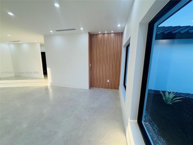 empty room with recessed lighting, visible vents, and baseboards