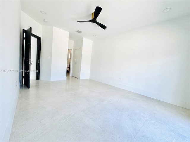 empty room with visible vents, baseboards, and a ceiling fan