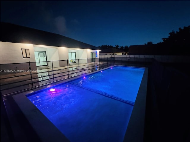 view of pool at night