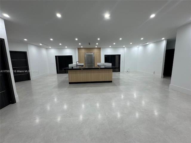 kitchen featuring dark countertops, open floor plan, recessed lighting, and modern cabinets