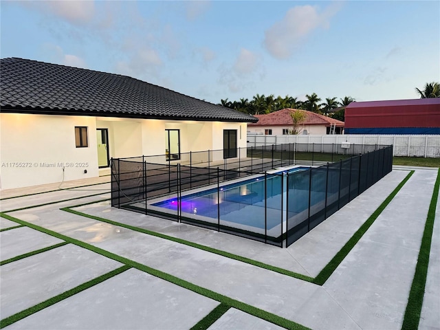 view of pool with a patio area, a fenced in pool, and fence