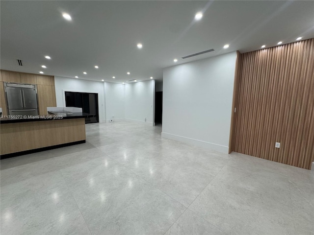 unfurnished living room with recessed lighting, visible vents, and baseboards