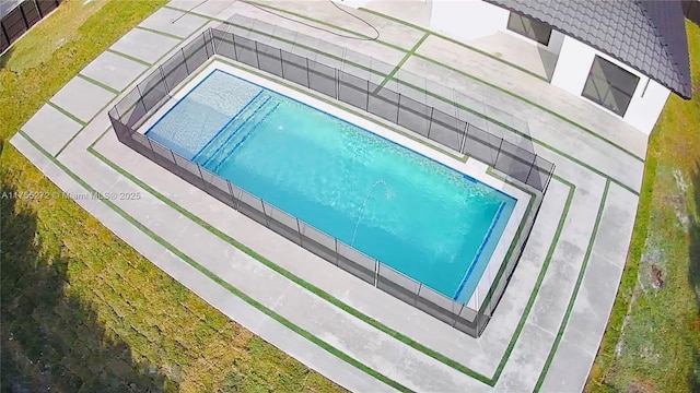 view of swimming pool featuring fence