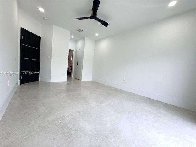 spare room with a ceiling fan, visible vents, baseboards, recessed lighting, and concrete flooring