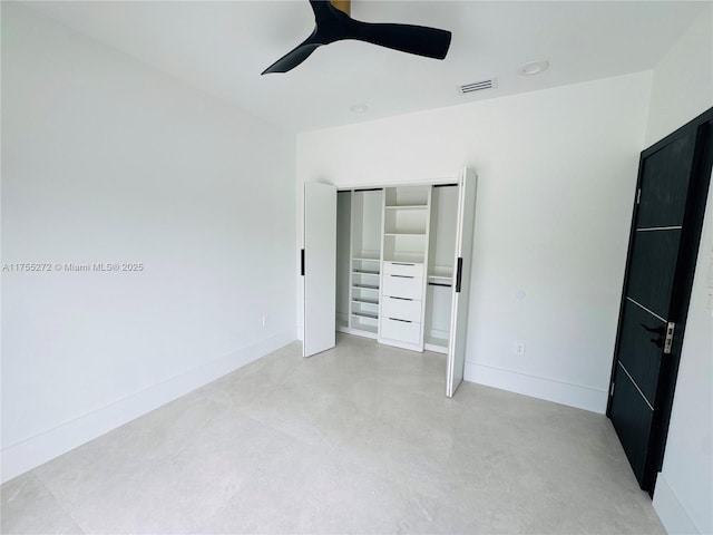 unfurnished bedroom featuring visible vents, concrete floors, ceiling fan, baseboards, and a closet