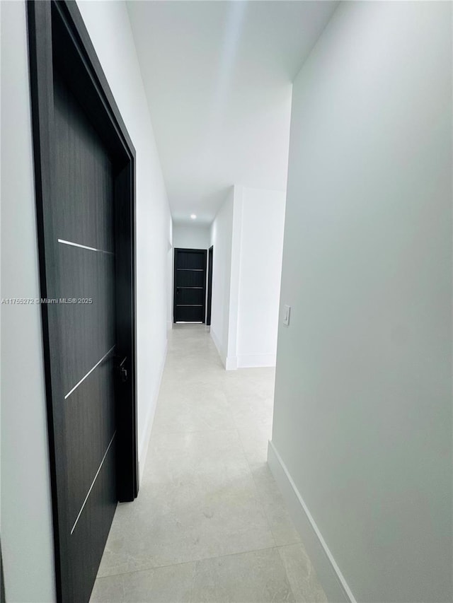 hallway featuring baseboards