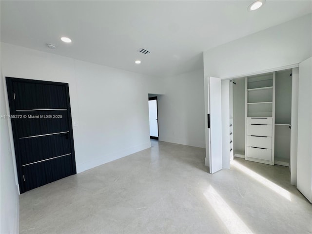 spare room featuring recessed lighting, visible vents, and concrete floors