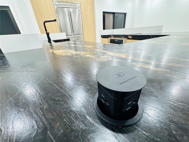 interior details featuring a sink and built in fridge