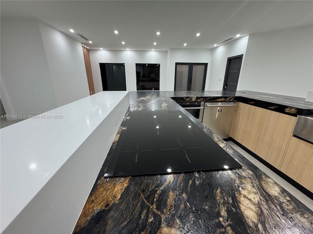 kitchen with modern cabinets, marble finish floor, light brown cabinetry, stainless steel dishwasher, and recessed lighting