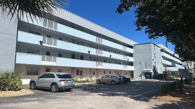 view of building exterior with uncovered parking