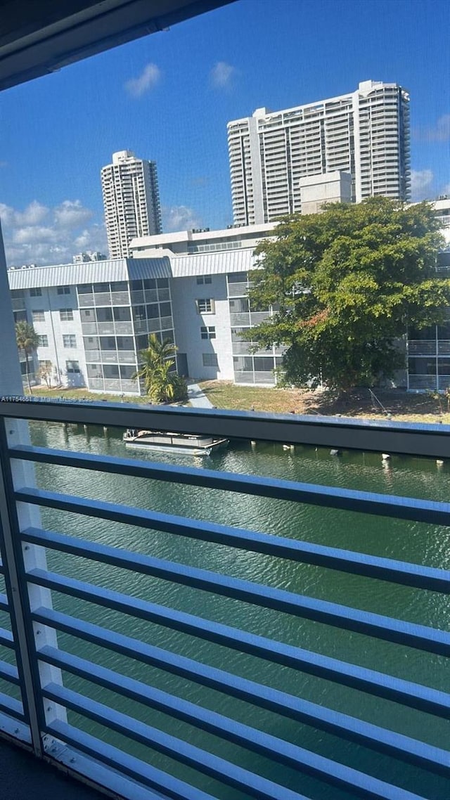 exterior space with a water view and a city view