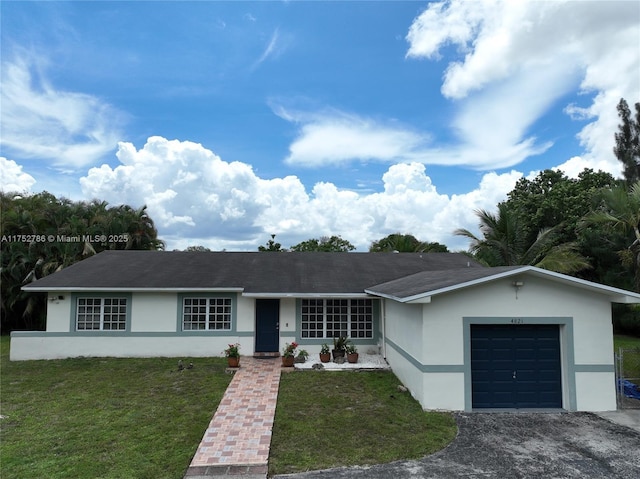 ranch-style house with a garage, a front lawn, and stucco siding