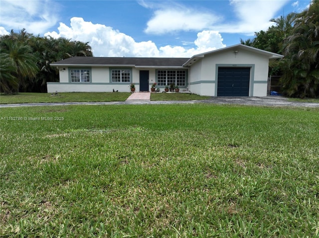 single story home with a garage, aphalt driveway, a front yard, and stucco siding