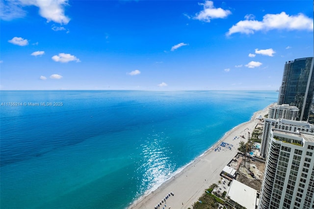 bird's eye view featuring a water view and a beach view