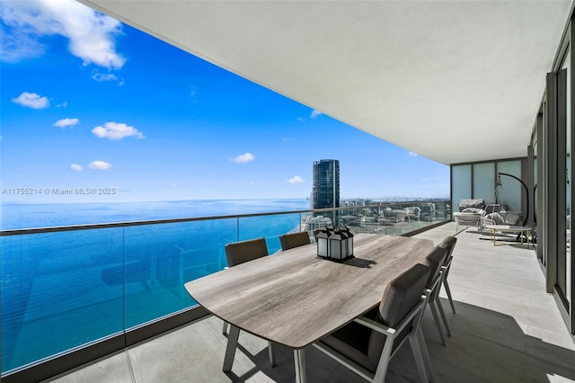 balcony featuring a view of city and a water view