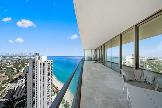 balcony featuring a city view and a water view