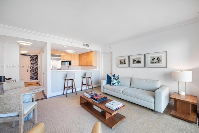 living room with baseboards, light colored carpet, visible vents, and crown molding