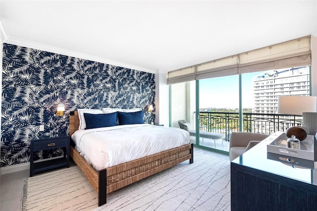 bedroom with wallpapered walls, ornamental molding, and access to exterior