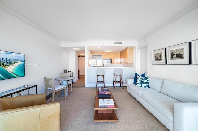 carpeted living room with baseboards, visible vents, and crown molding