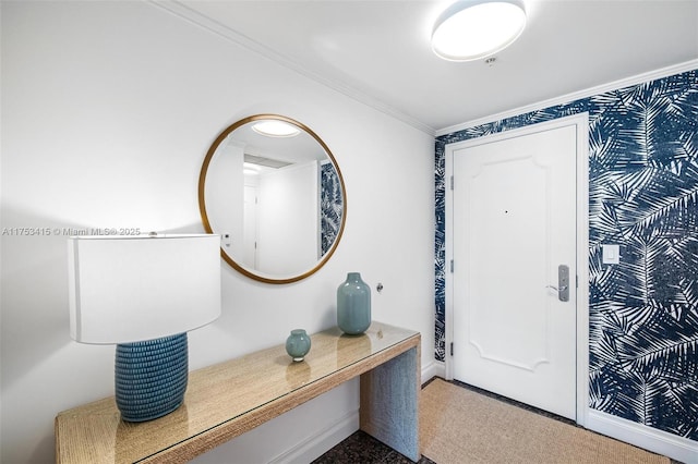 foyer entrance featuring ornamental molding, visible vents, and baseboards