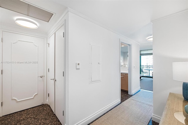 hall featuring carpet floors, electric panel, crown molding, and visible vents