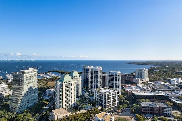 birds eye view of property with a view of city and a water view