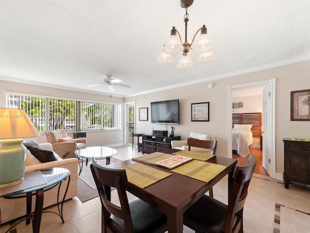 dining room featuring light tile patterned floors, baseboards, ornamental molding, a textured ceiling, and ceiling fan with notable chandelier