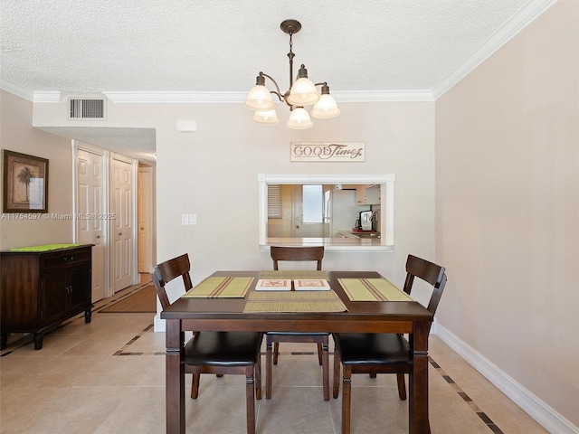 dining room featuring a textured ceiling, light tile patterned floors, visible vents, baseboards, and ornamental molding