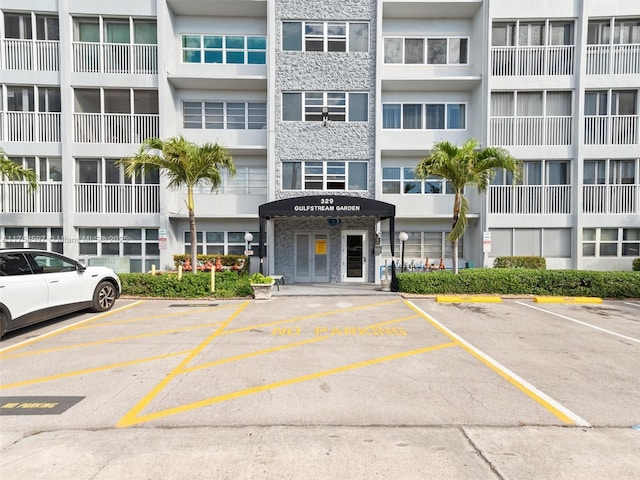 view of building exterior featuring uncovered parking