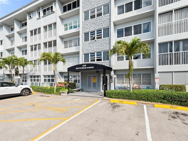 view of building exterior featuring uncovered parking